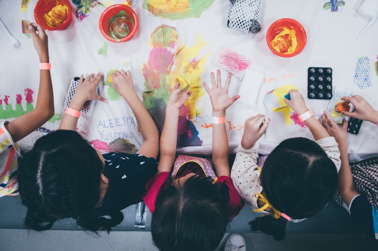 cute babies at birthday party doing art and craft